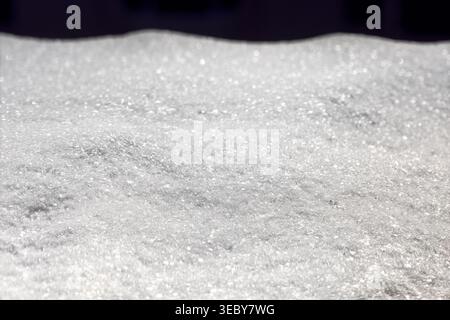 Pristine blanket of fresh snow stretches across the frame, its crystalline surface glistening with countless tiny sparkles Stock Photo