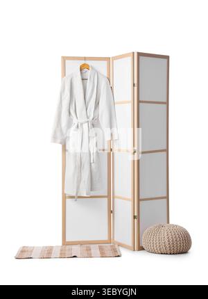 Modern folding screen with pouf and bathrobe isolated on white background Stock Photo