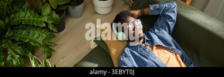 Black Adult Man Relaxing with Headphones for Mindfulness at Home Stock Photo