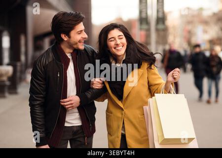 Excited couple doing shopping on weekend together Stock Photo