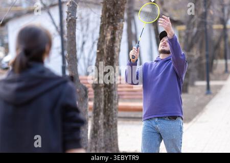 Man Hitting a Shuttlecock During Outdoor Badminton Stock Photo