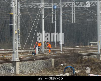 Gliwice, Poland - December 3, 2025: Team of dedicated workers in safety gear diligently working on railway tracks, symbolizing essential infrastructur Stock Photo