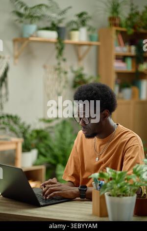 Black Adult Man Working on Laptop in Home Office for Remote Work Stock Photo
