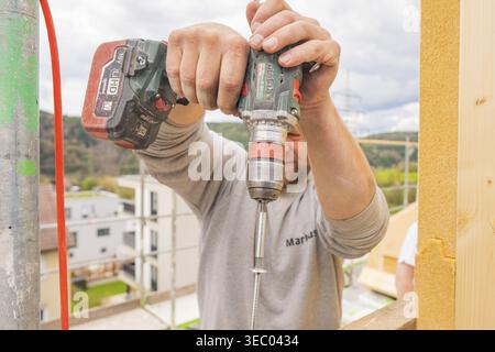 Construction worker using a drill on a construction site, residential renovation, Nagold, Calw district, Germany Stock Photo