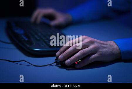 Person Using a Computer Mouse and Keyboard in a Dimly Lit Room During Nighttime Stock Photo