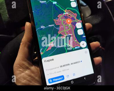 Kirov, Russia - November 10, 2024: A person is using a smartphone to view a map while planning travel in Kirov during a road journey. The location is Stock Photo