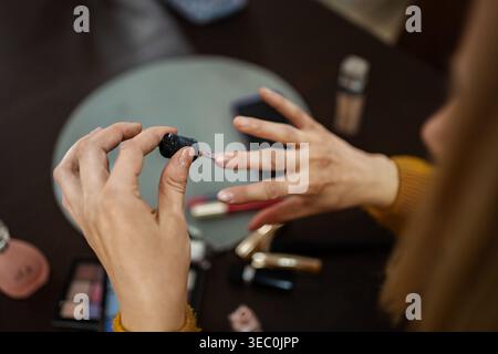 Creating elegance with nail polish in a cozy makeup space on a relaxed afternoon Stock Photo