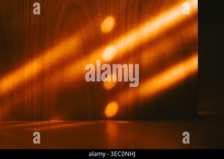 Graphic composition of golden light beams and circular bokeh reflections on a natural wood surface. Minimalist background with warm tones, organic tex Stock Photo