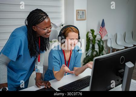 Healthcare professionals collaborating on computer using telemedicine technology Stock Photo