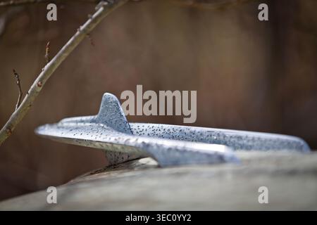 Close-up view of a vintage truck outdoors in a rural setting, showing fading paint, peeling sheet metal, rusted edges, and worn details that reveal ye Stock Photo