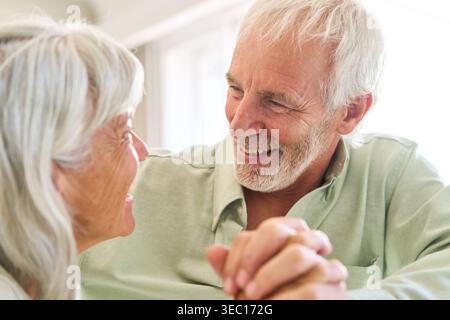 A senior couple's enduring love and trust, showcasing a happy elderly man and woman sharing a joyful moment. Stock Photo