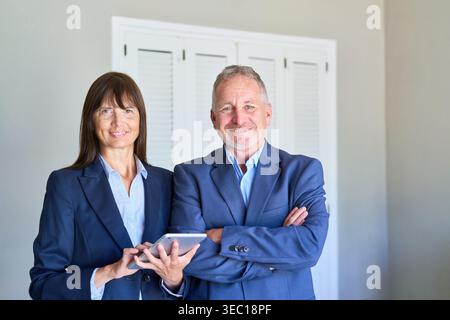 A senior couple engages in financial planning, seeking professional advice for their retirement, estate, and asset management. Stock Photo