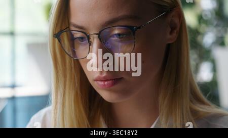 Portrait Caucasian businesswoman working concentrated serious business woman female student girl studying learning indoors professional in glasses Stock Photo