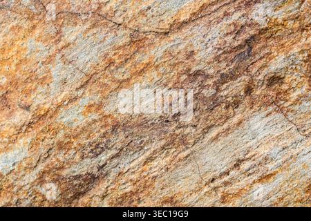 Beautiful warm natural stone texture background showing rough rock pattern surface with rich brown and orange mineral layer providing peaceful calming Stock Photo