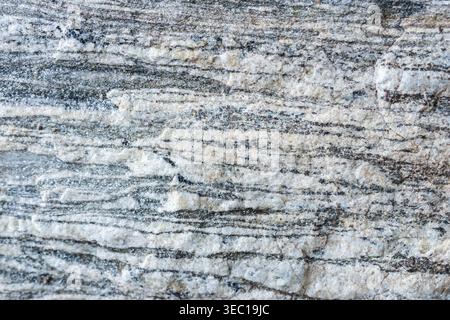 Detailed view of natural stone texture showing horizontal lines and layers creating calm abstract pattern on rock surface Stock Photo