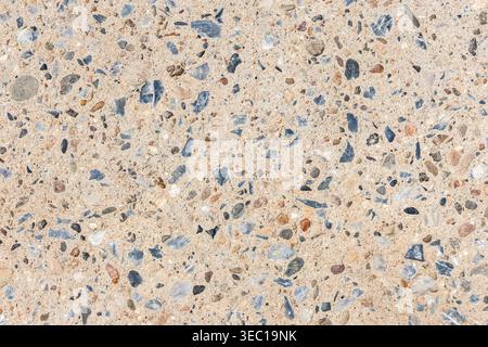 Close up texture of exposed aggregate concrete surface showing small stone and pebble pattern creating natural gravel background giving very calm and Stock Photo