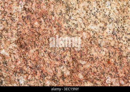 Natural stone granite texture background surface pattern displaying solid pink and brown colors evoking calm steady feeling for abstract macro detail Stock Photo