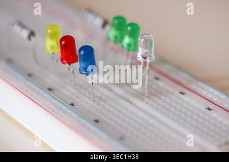 Colorful LED components on breadboard with shallow depth of field, electronics concept Stock Photo