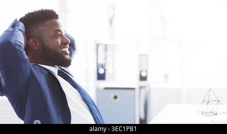 Happy young manager having break in office Stock Photo