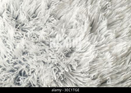 White fluffy faux fur texture background, soft shaggy carpet textile detail Stock Photo