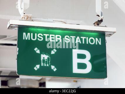 Illuminated Green Muster Station B Emergency Assembly Sign on a Cruise Ship Stock Photo