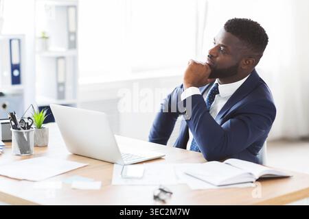 Thoughtful businessman making business solution at workplace Stock Photo