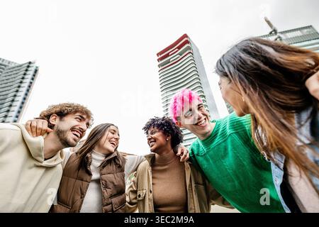 Multiracial young group of student friends laughing together outside Stock Photo