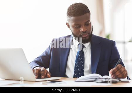 Young businessman making market research, sitting in office Stock Photo