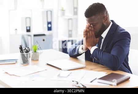 Young tired businessman having stress at work Stock Photo