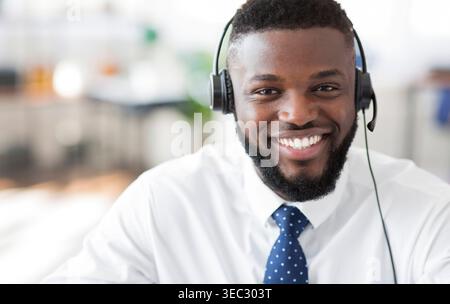 Smiling Customer Service Representative Wearing Headset in Modern Office Setting Stock Photo