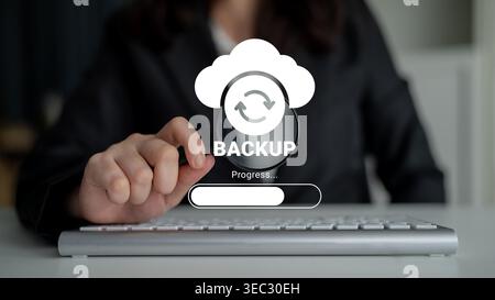 A business person interacts with a backup progress interface on their keyboard, highlighting modern approaches to digital data management and security Stock Photo