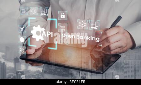 Businessman Using Tablet to Explore Open Banking Solutions with API Integration and Digital Icons Representing Financial Services Gluon. Stock Photo