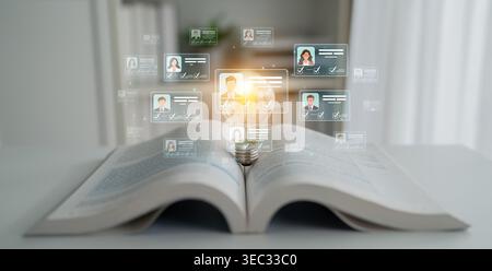 Open Book with Light Bulb Symbolizing Knowledge and Learning, Surrounded by Digital Profiles and Information in Modern Office Environment Sigmoid Stock Photo