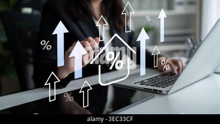 A businesswoman focuses on analyzing market trends using a laptop in a modern office, highlighted by graphic symbols of growth and percentages Stock Photo