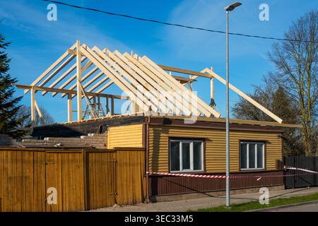 Wooden roof frame under construction on residential house renovation project in suburban area Stock Photo