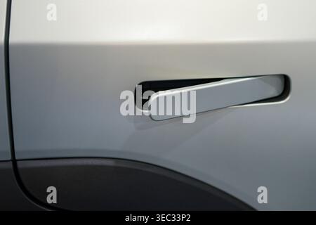 Modern white electric car door handle close-up with flush design and sleek automotive detail Stock Photo