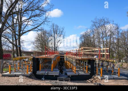 Bridge under construction with scaffolding support structure and safety rails under blue sky Stock Photo