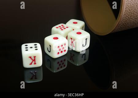 a pair of white dice with a dice on the black background Stock Photo