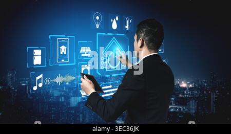 Business professional interacting with futuristic smart home technology interface in a city skyline at night with digital icons and data streams Quark Stock Photo