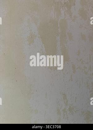 Textured wall surface in neutral tones suitable for use as a background or copy space. Mobile photo Stock Photo