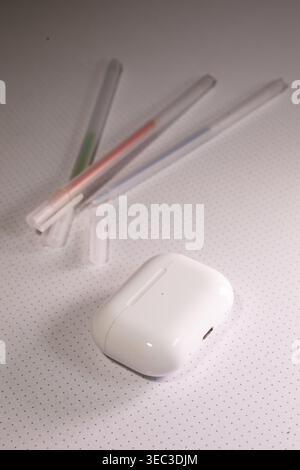 White headphones Case with Transparent Pens on Dotted Background Stock Photo