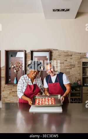 Chefs showing tray of small appetizers during cooking course Stock Photo