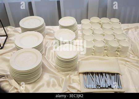 The tablecloth is white and the table is covered with a white cloth Stock Photo