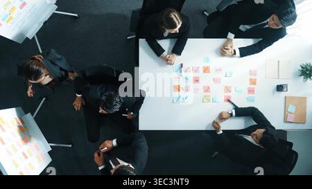 Top view of smart business group write marketing idea at whiteboard while present to executive manager. Investor clapping hands to celebrate Stock Photo