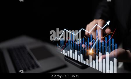 A close-up view of hands analyzing financial growth chart data with digital indicators on a laptop used for business insights and market trends Stock Photo