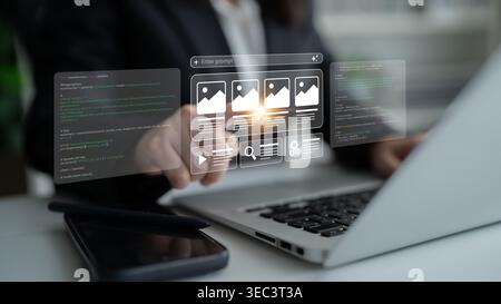 A professional person utilizes a laptop and a holographic interface in a modern office, showcasing digital marketing strategies through data Stock Photo