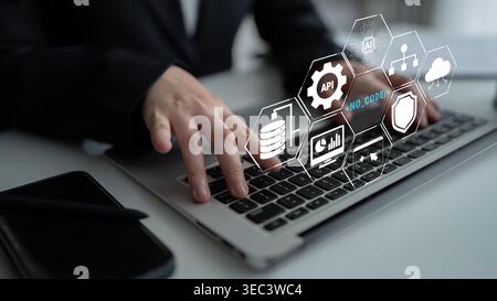 Business professional working on laptop with digital interface showcasing technology, data management, and modern software solutions for digital Stock Photo