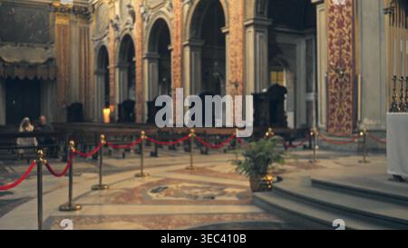 Ornate interior with soft defocused bokeh capturing blurred arches, marble floor and roped aisles in warm light, shallow focus church; background back Stock Photo