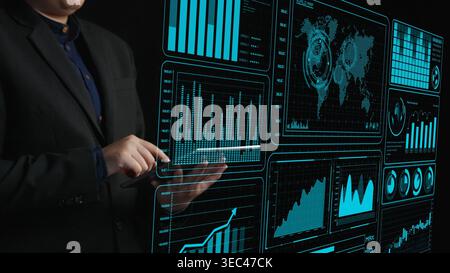 A professional business analyst interacts with a futuristic data visualization interface, exploring trends and insights to drive strategic decisions Stock Photo