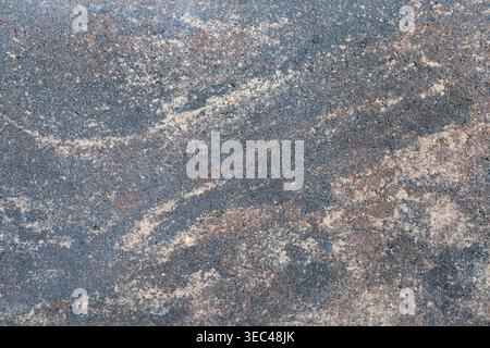 Natural dark grey granite texture with light sand-colored veins. Rough stone surface background for architectural design, 3D rendering, or constructio Stock Photo